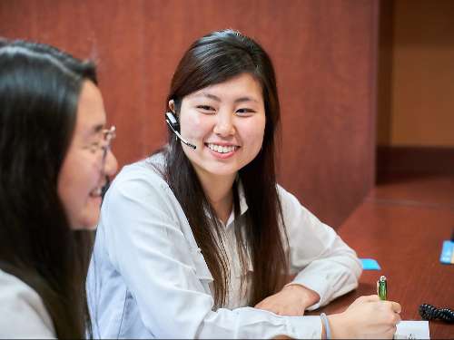 Receptionist explaining digital records to a patient