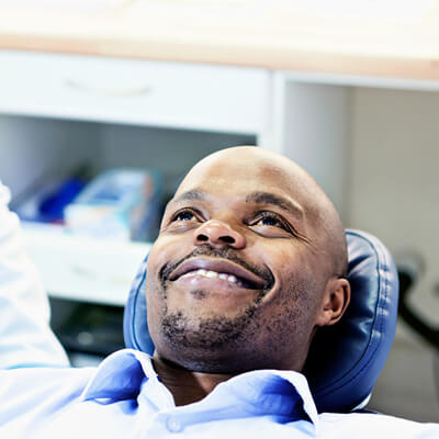 A man lying in the dental chair after being sedated