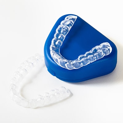 A Mouth Guards on top of a blue case to show that we offer this oral appliance as part of our family dentistry in Renton, WA